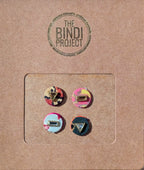 Set of four 14mm round textile bindis with colorful geometric and abstract designs on brown card backing.