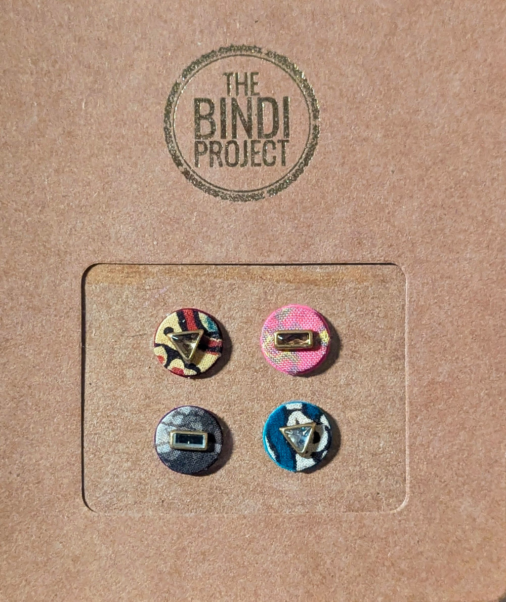 Set of four 14mm round textile bindis in pink, beige, blue, and multicolor with upcycled fabric patterns.