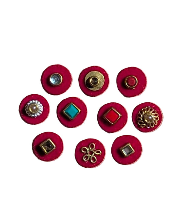 Set of ten 10mm red bindis with varied gold, blue, and black geometric and floral designs on kraft paper background.