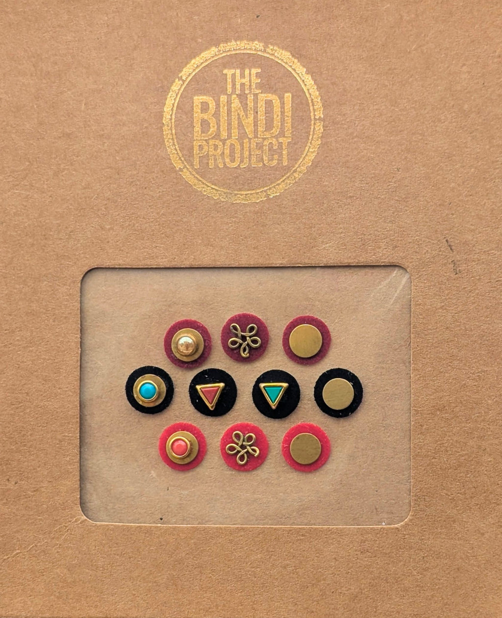 Set of 10 small round 10mm statement bindis in pink, black, and blue with gold accents and decorative designs.