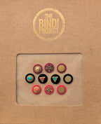 Set of 10 small round 10mm statement bindis in pink, black, and blue with gold accents and decorative designs.
