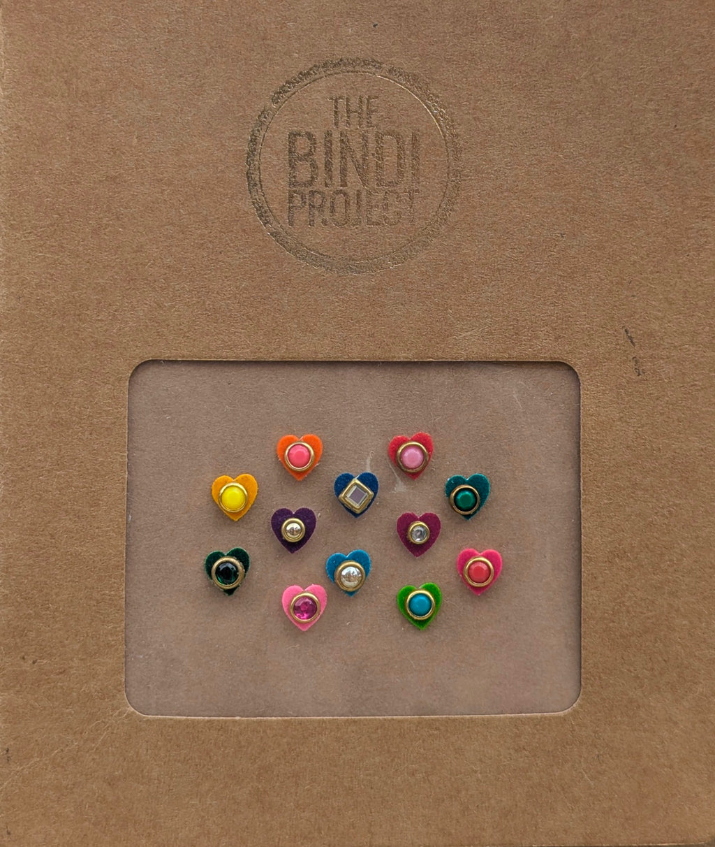 Set of 12 small multicolor stone bindis in heart shapes on a brown textured card.